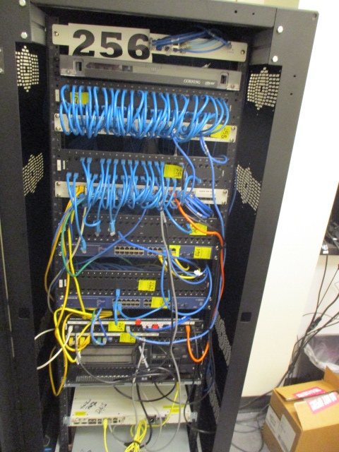 A bunch of wires are connected to the back of a rack.